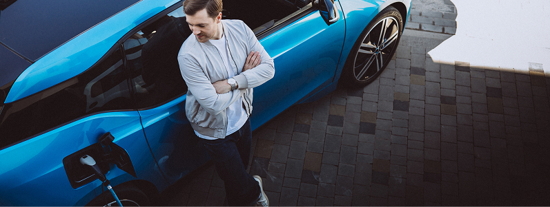 person leaning on a blue car