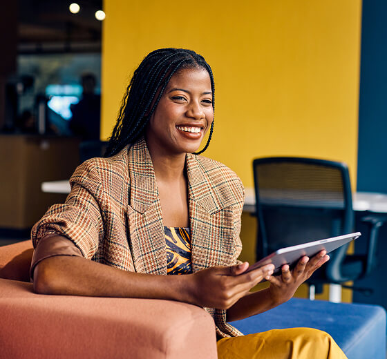 business person using a tablet with orange background