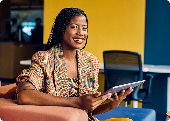 business person using a tablet with orange background